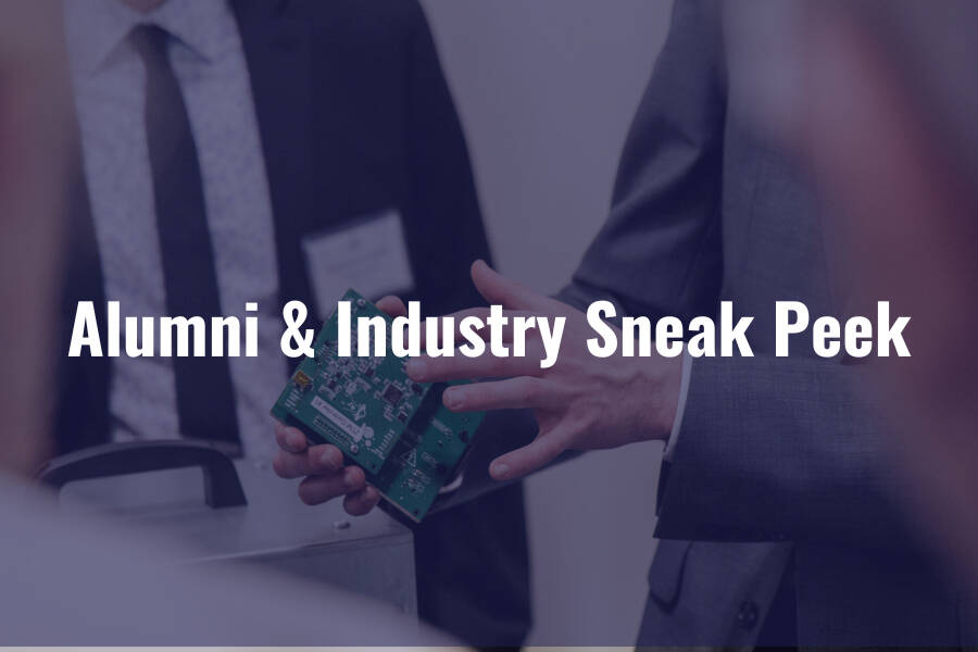 Professionals in suits examine a circuit board